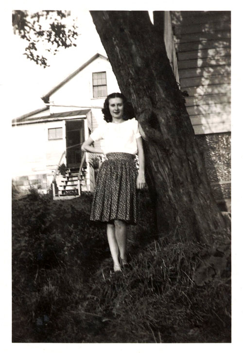 Helen standing by a tree