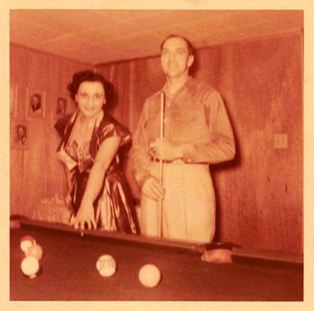 Christine and Freer playing pool at their home.