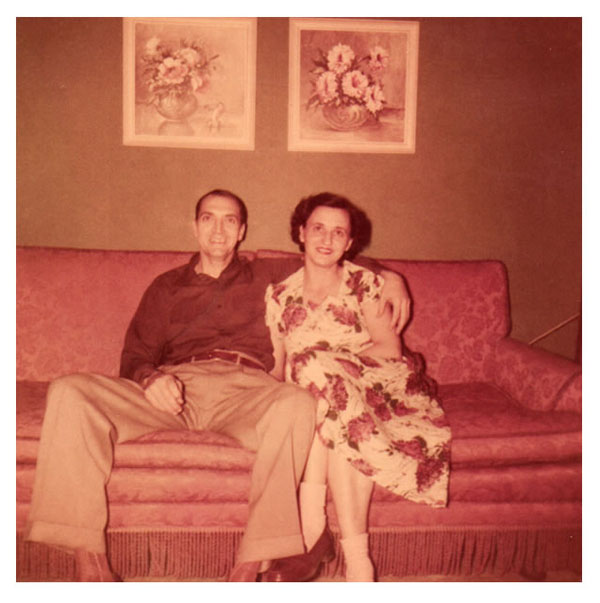 Freer and Christine sitting on red sofa 1951